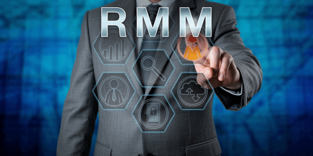 Businessman pointing at an RMM interface, symbolizing proactive IT management and remote device monitoring.